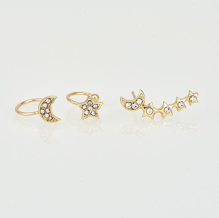 Set of gold rings with star and moon designs on a light gray background