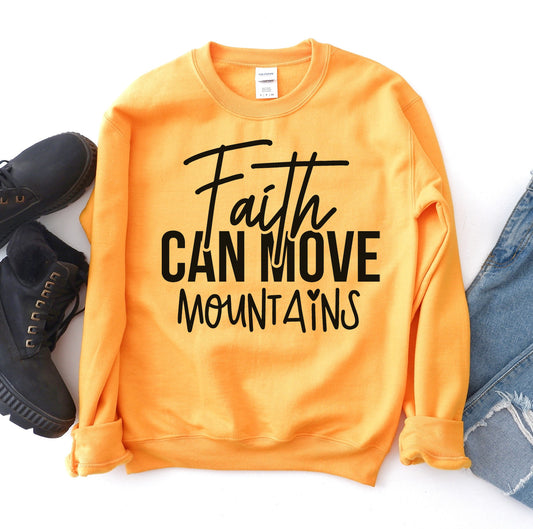 Orange sweatshirt with 'Faith Can Move Mountains' text, paired with black shoes and blue jeans on a white background.