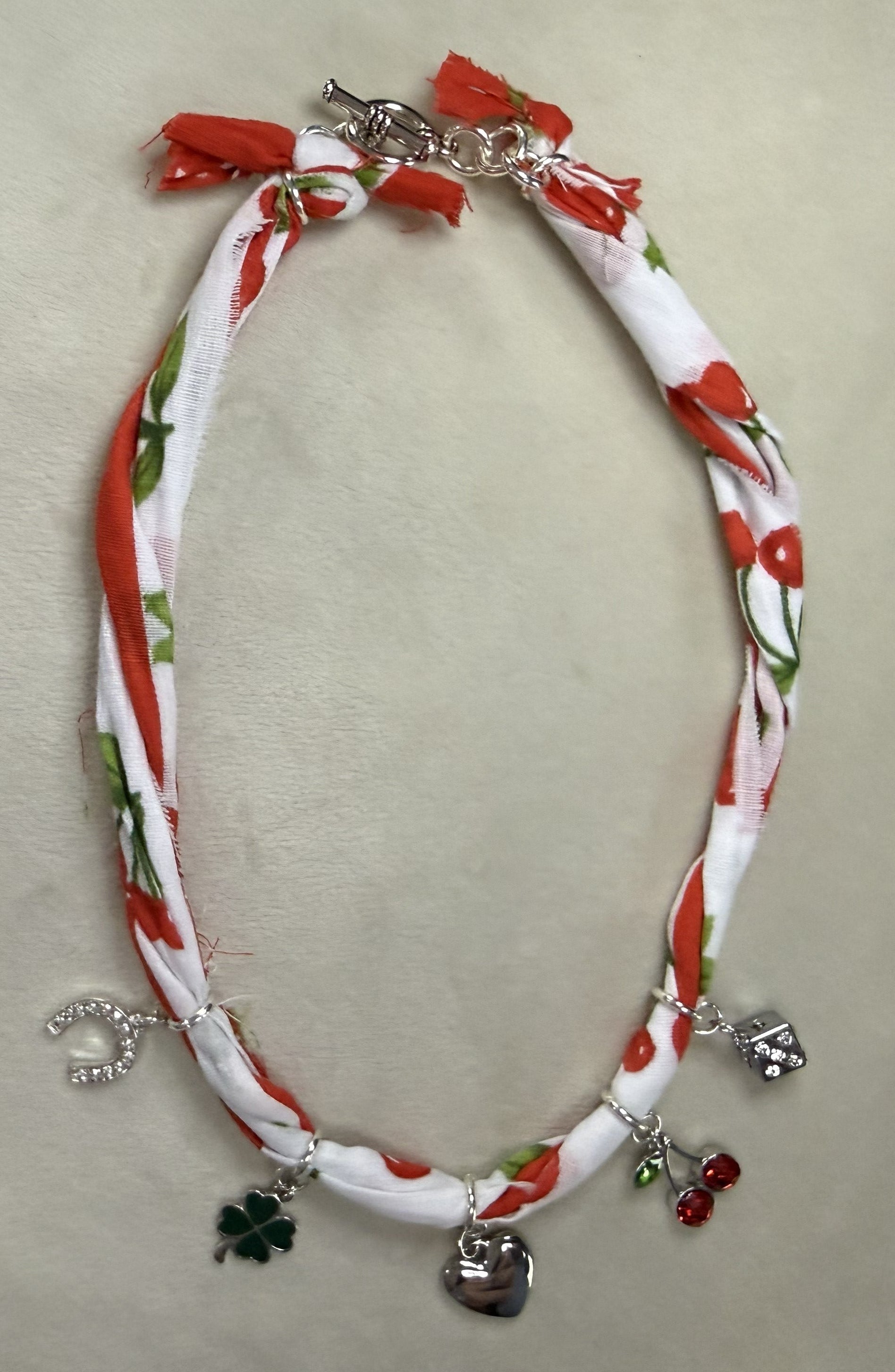 Necklace with charms on a white surface