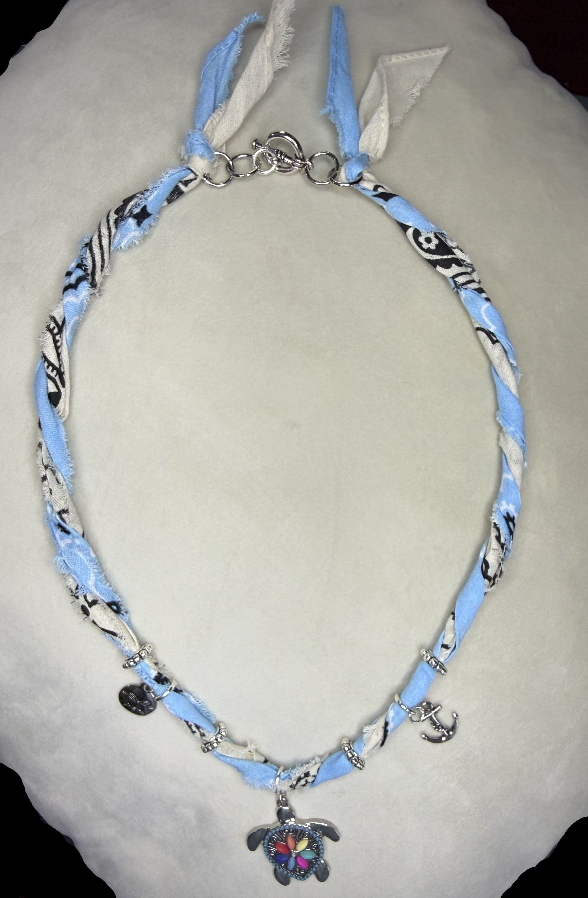 Necklace with blue and white pattern on a light gray surface