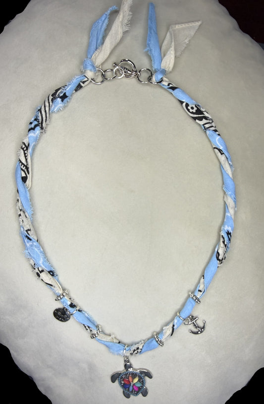 Necklace with blue and white pattern on a light gray surface