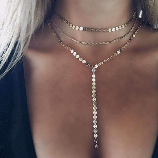 Necklace with beads and chain on a person's neck